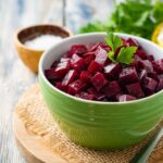 Beetroot salad with parsley in bowl on rustic wooden table