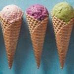 ice cream scoops in cones with copy space on blue