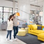 Two people discussing furniture models in a modern furniture shop