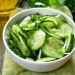 Cucumber salad in white bowl