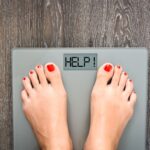 Lose weight concept with person on a scale measuring kilograms