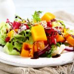 Salad with slices of pumpkin on a plate
