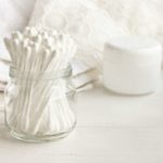 Cotton swabs in glass jar, white.
