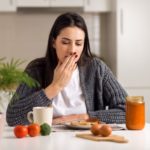Young  woman feeling nausea during breakfast time