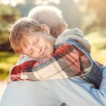 Grandfather and grandson together outdoors family concept