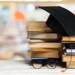 A pile of books on wooden table