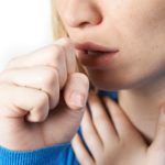 Close Up Of Woman Suffering With Cough