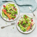 Healthy spring salad with grilled salmon, orange, olives and quinoa