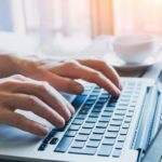 hands of business person working on computer