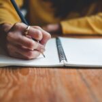 Close up woman hand writing on notebook
