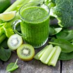 fresh green smoothie on wooden surface