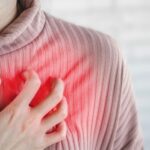 Asian woman hand touching her chest  having heart attack