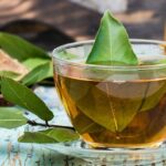 Fresh tea from bay leaf in a cup on a wooden rustic table