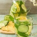Cold summer drink of ginger, cucumber, mint and lemon in a jug and glass – Cool detox.