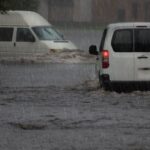 Motion Cars on a flooded city road at the rain day