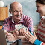 Olderly Spanish man gives his daughter money for a mortgage or student loan.