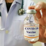 Infectious doctor show COVID 19 vaccine for prevention,immunization and treatment for new corona virus infection(COVID-19,novel coronavirus disease 2019 or nCoV 2019 from Wuhan). Medical technology.