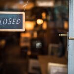 Closed – sign hanging on glass door