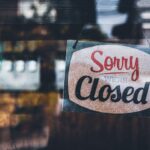 Sorry we’re closed . grunge image hanging on a cafe window, Coronavirus COVID-19 outbreak lockdown.