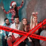 Quarantine, stay home. Coronavirus red warning tapes against friends taking selfie by pink smartphone, posing at decorated Christmas tree. Close up