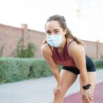 Sporty Woman With Mask Taking Rest After Running