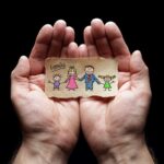 Child drawing of family with the protection of cupped hands
