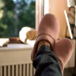 Woman wearing pink slippers with legs up relaxing