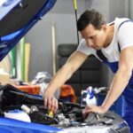 car mechanic in a workshop repairing a vehicle